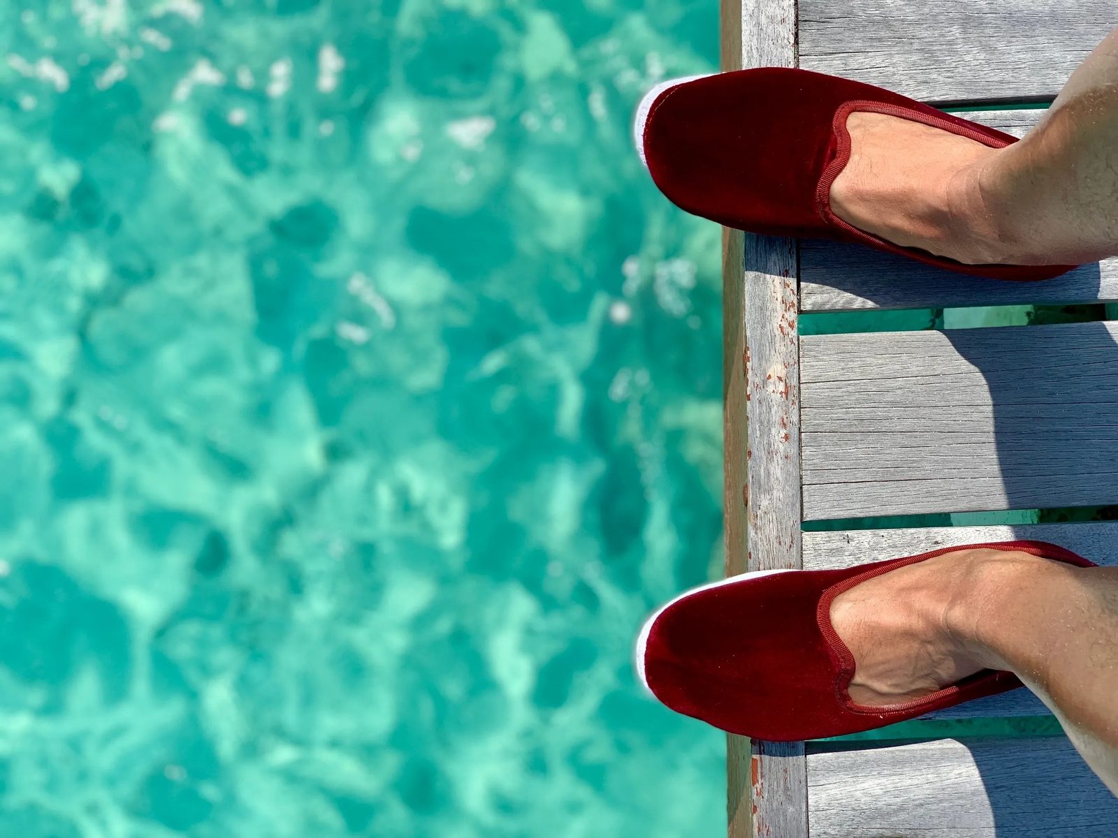 Burgundy velvet slippers on the weathered jetty at Park Hyatt Maldives Hadahaa