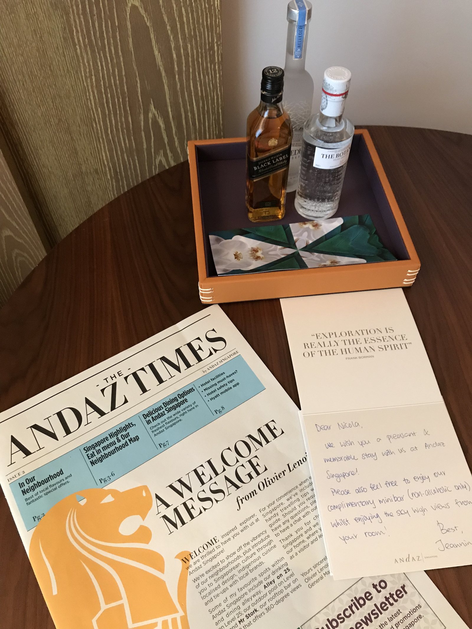 A folded newspaper headed The Andaz Times beside a handwritten welcome note