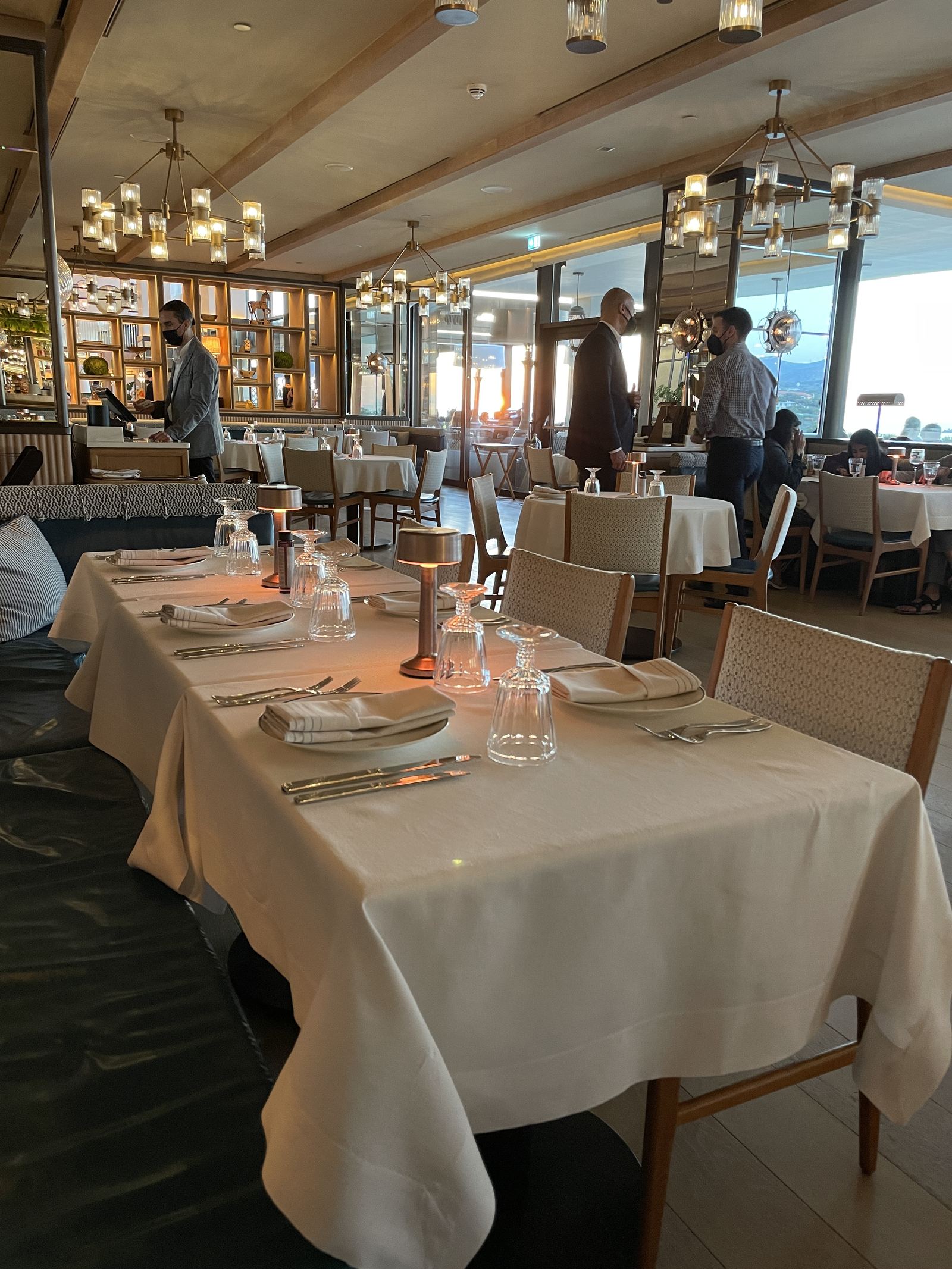 The dining room at Mercato laid for service, the gulf along one wall
