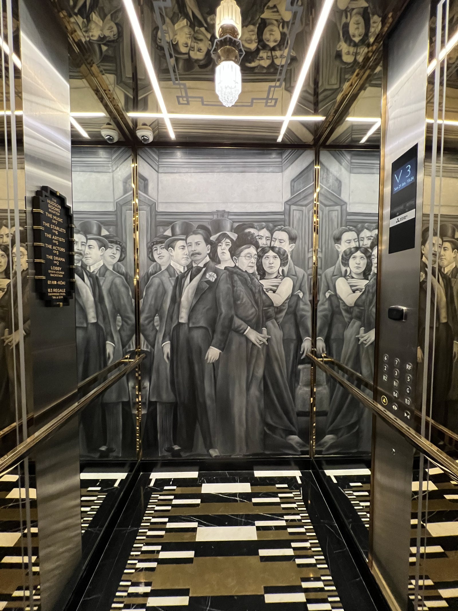 The inside of a lift lined with a painted crowd in evening dress, with brass rails and a tiled floor
