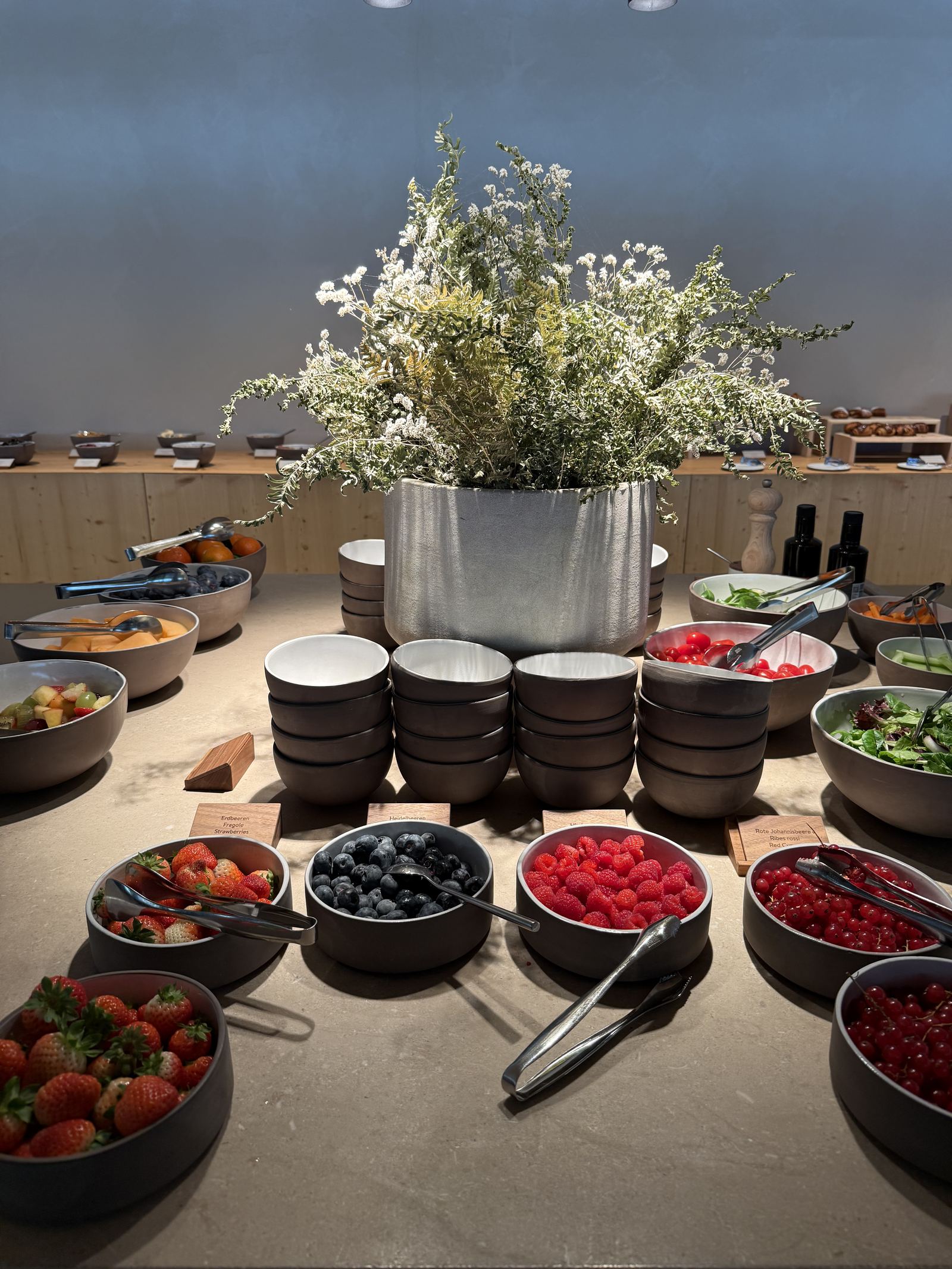 Bowls of raspberries, blueberries and redcurrants on the breakfast buffet