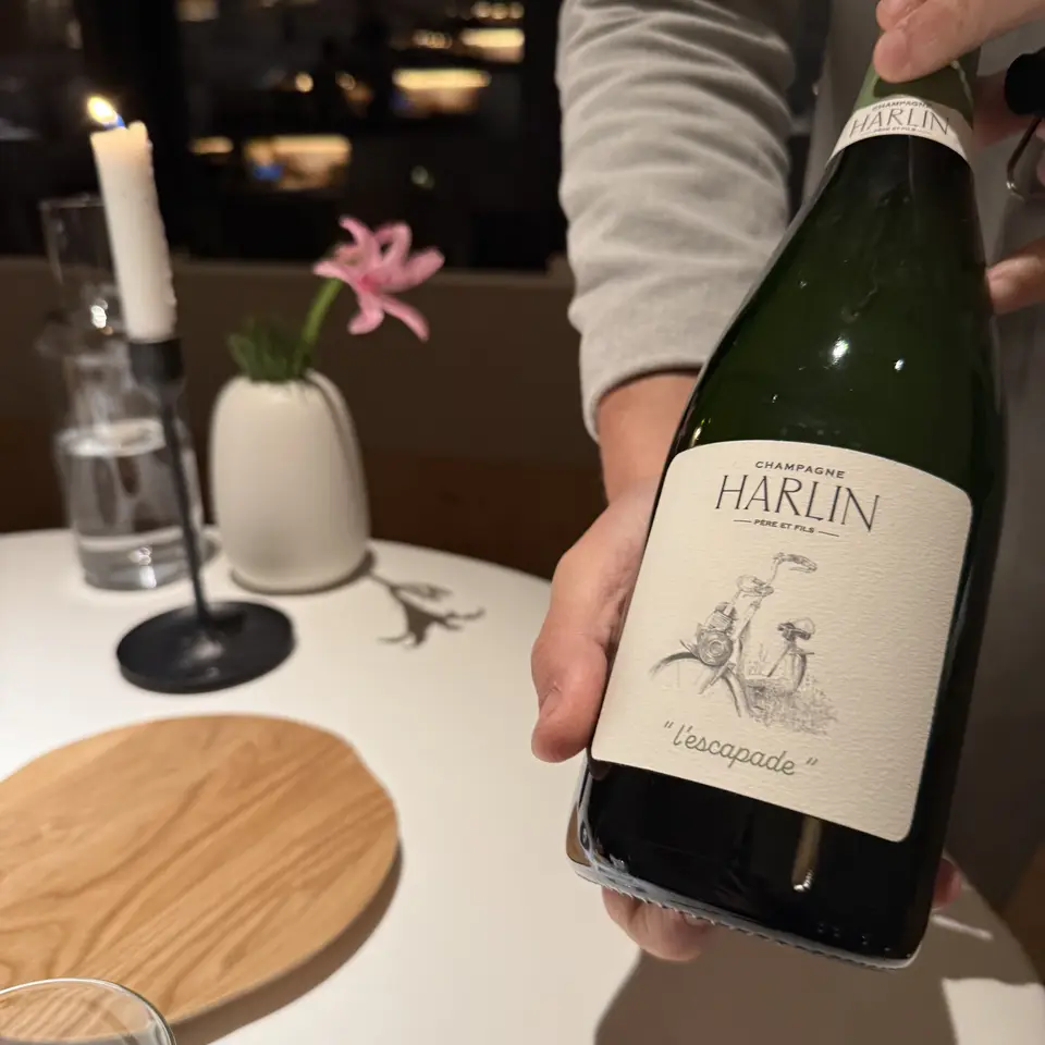 A bottle of Harlin champagne carried to the table at FORESTIS
