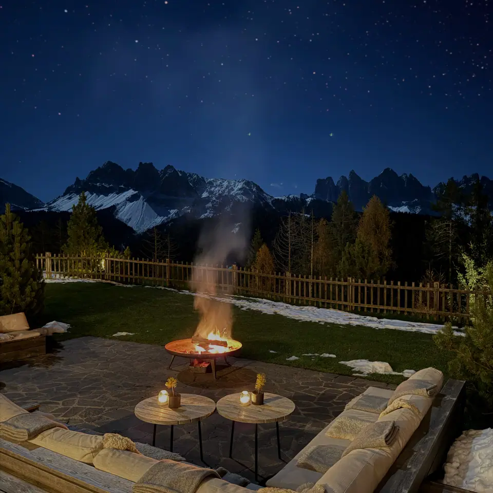 The garden fire pit at FORESTIS at night, under the Odle