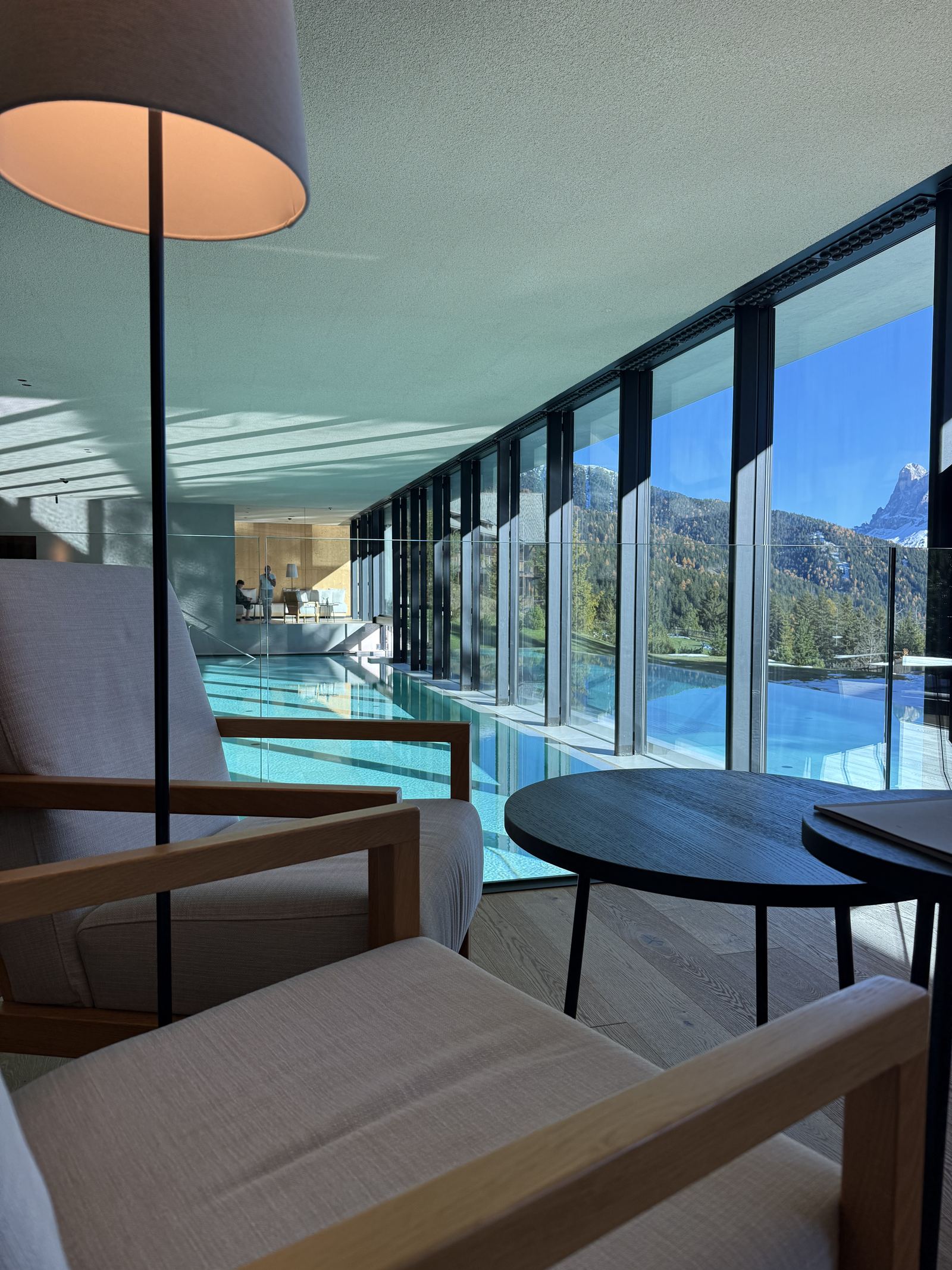 The indoor pool at FORESTIS in daylight with the mountains through the glazing