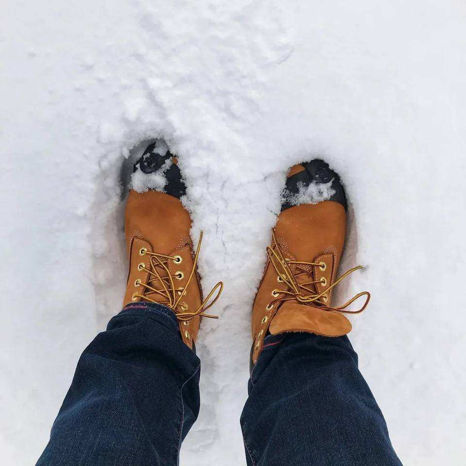 Wheat nubuck boots seen from above in fresh snow at FORESTIS in the Dolomites