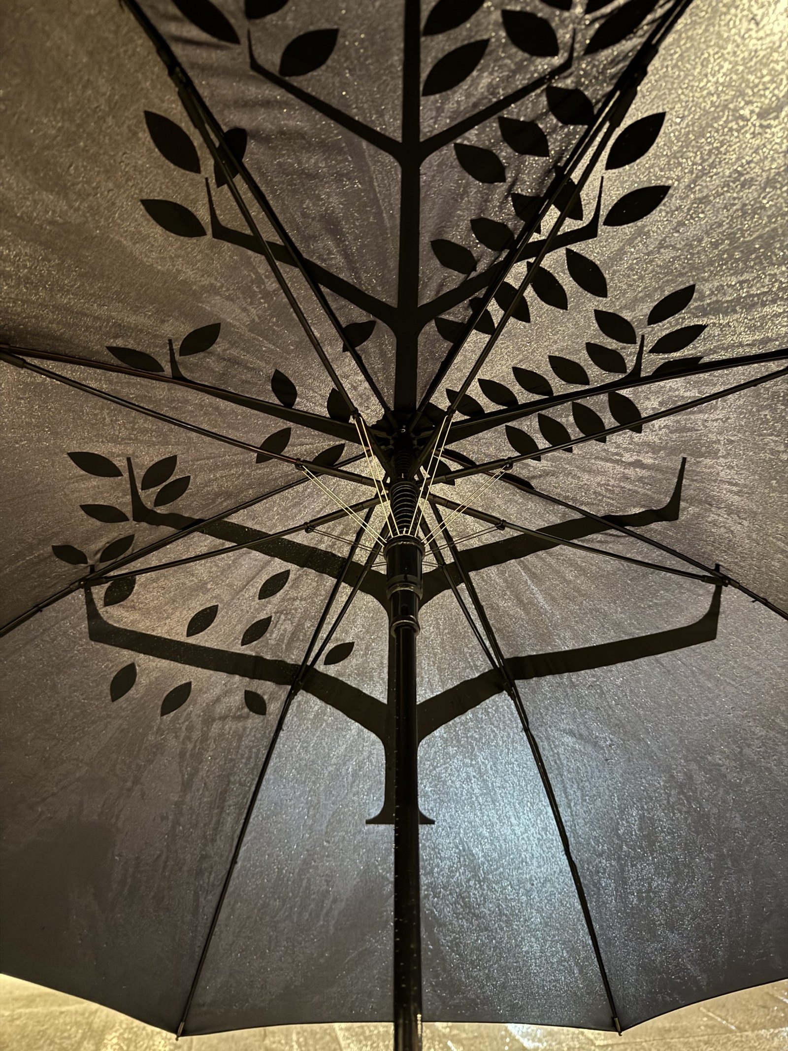 The underside of a hotel umbrella printed with the Four Seasons tree