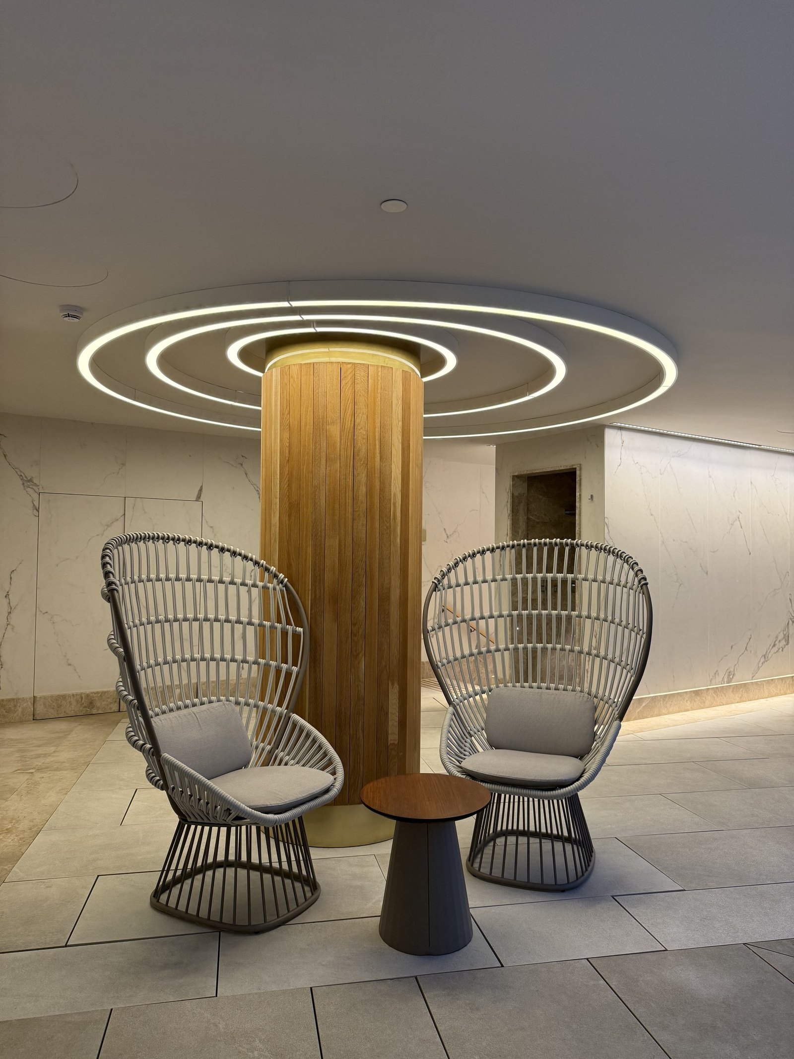 Two wicker chairs beside a fluted column in the spa