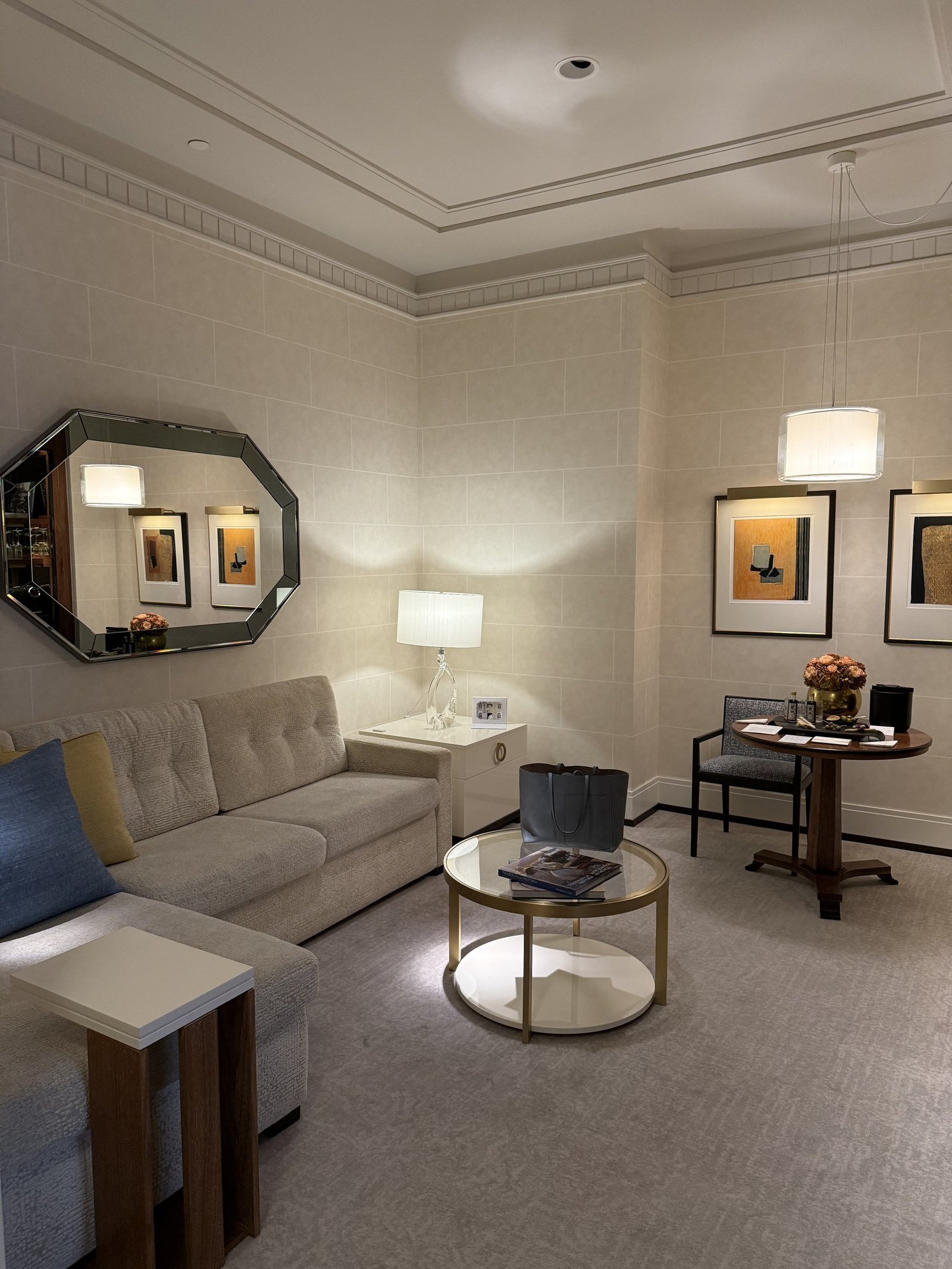 The living end of an Executive Suite with a sofa, armchairs and a low glass table