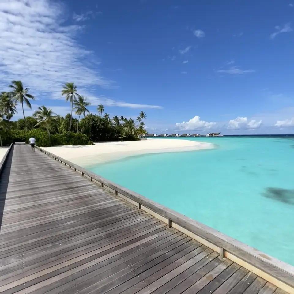 A timber boardwalk running along the beach at Hadahaa