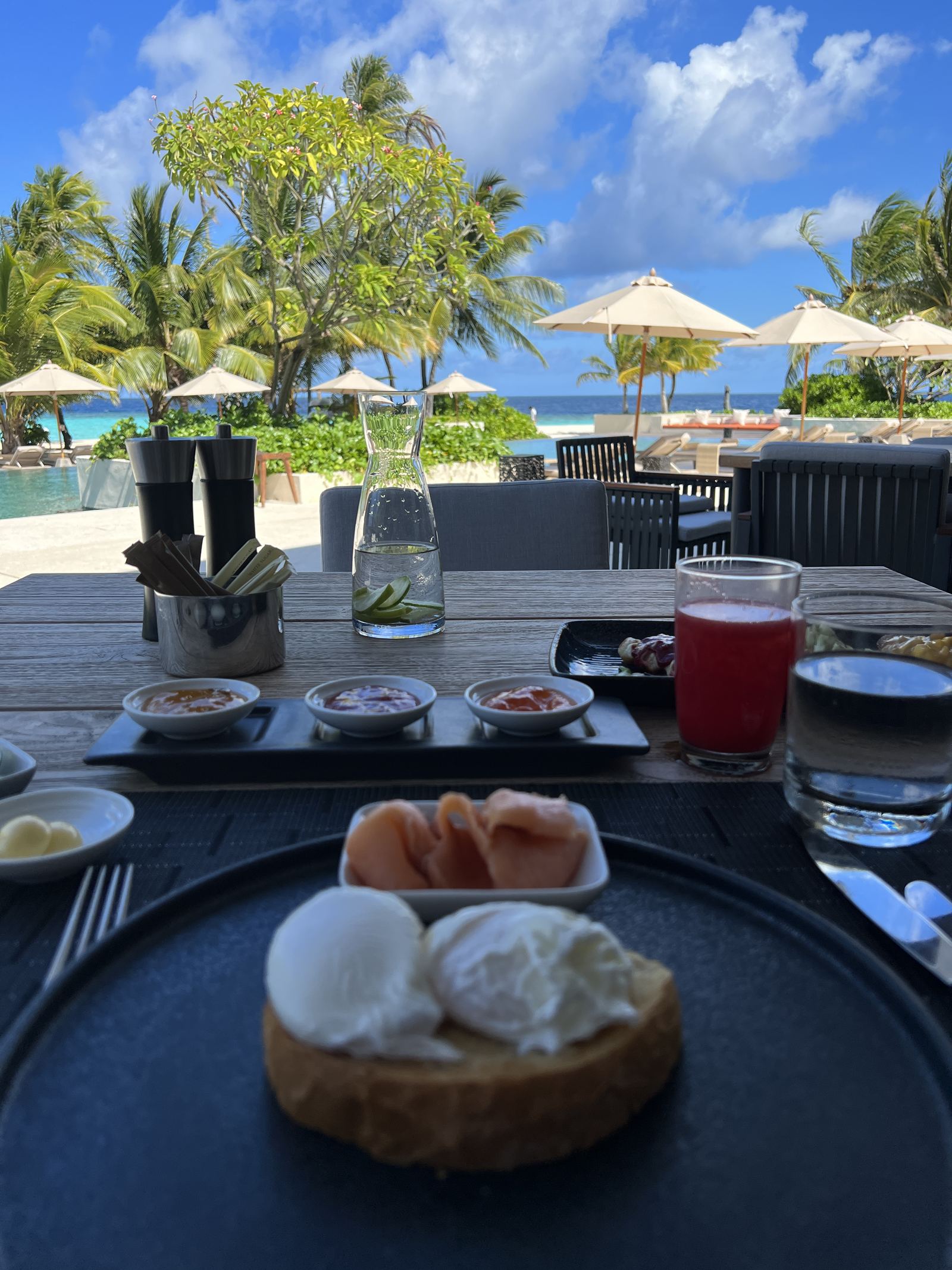 Poached eggs and ham on toast with a watermelon juice at breakfast