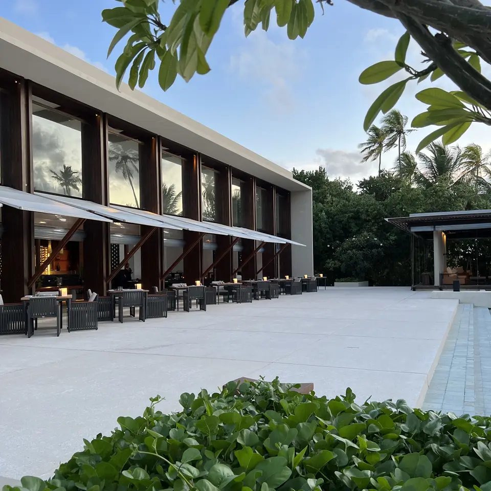 The low timber and glass building that holds the restaurant, seen from the garden