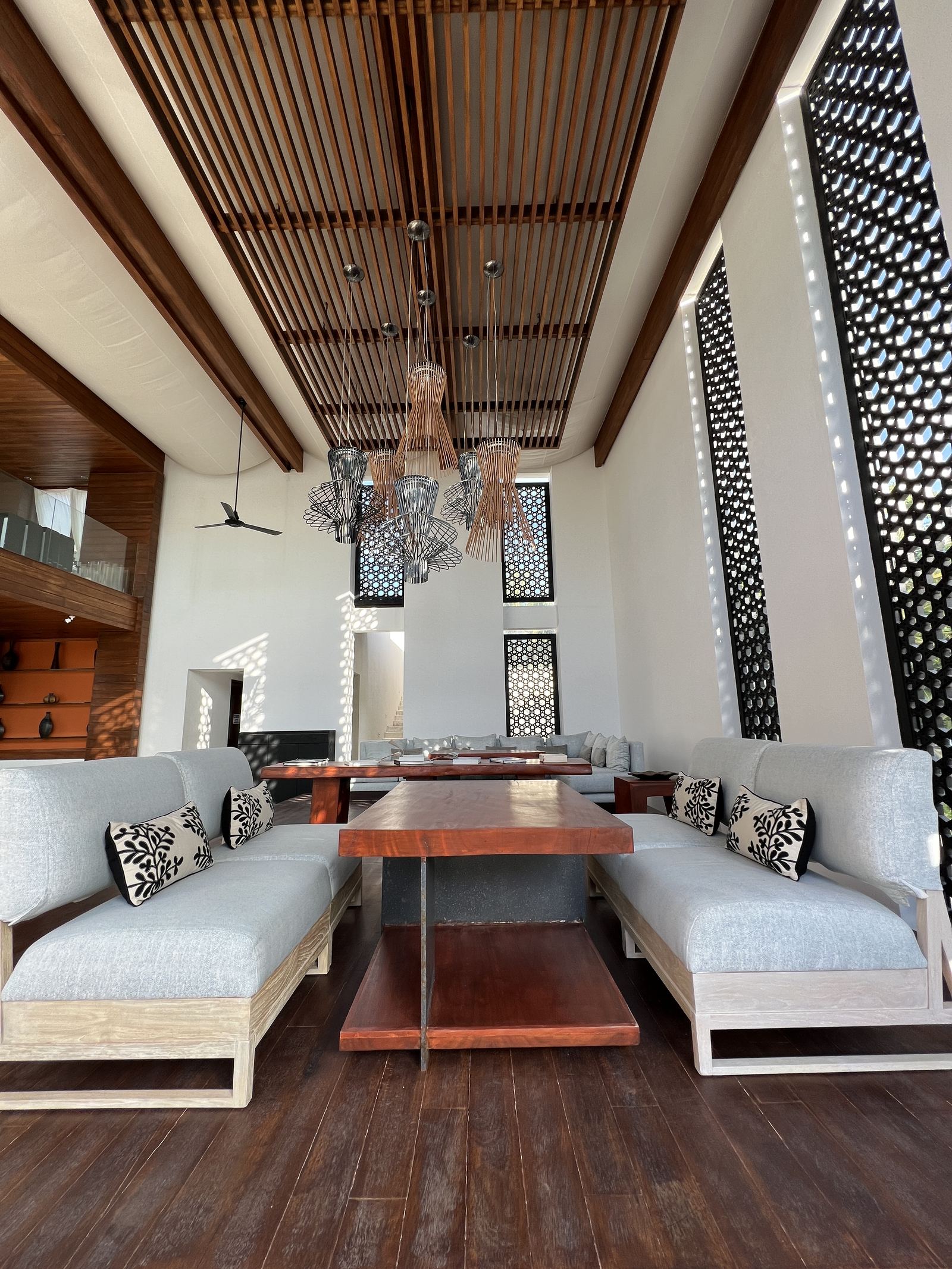 A lounge pavilion with a slatted timber ceiling and deep sofas