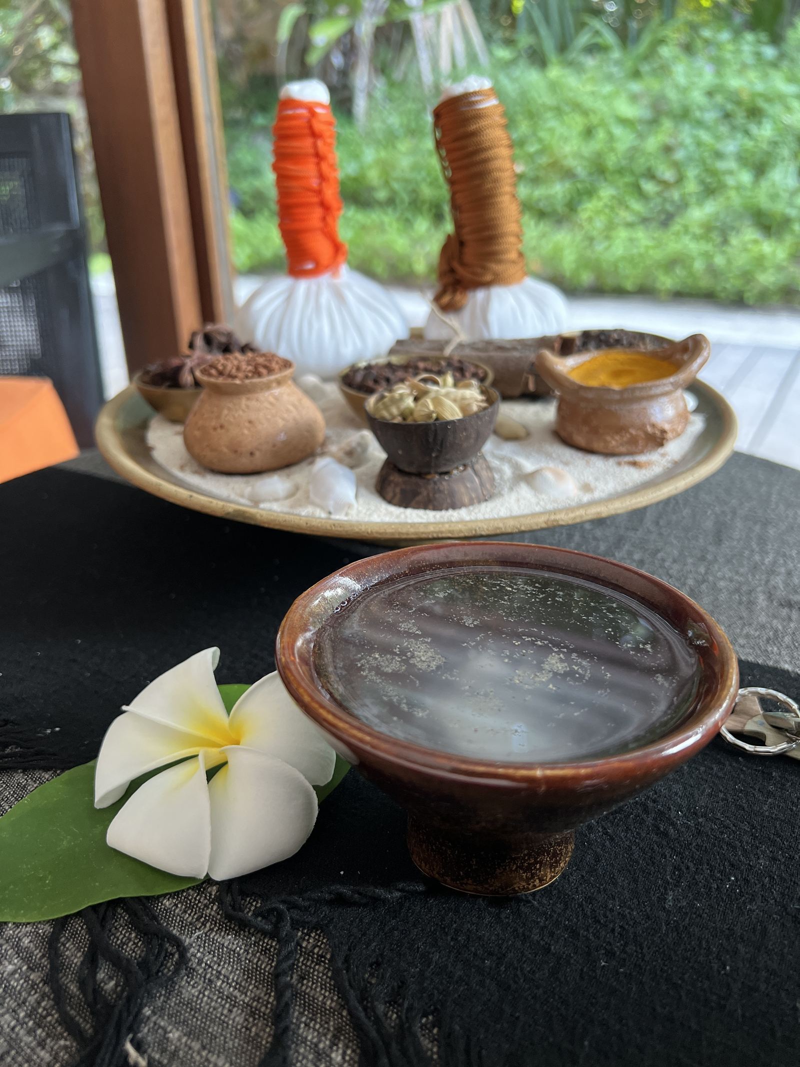 Herbal compresses and spices laid out on a tray at Vidhun Spa