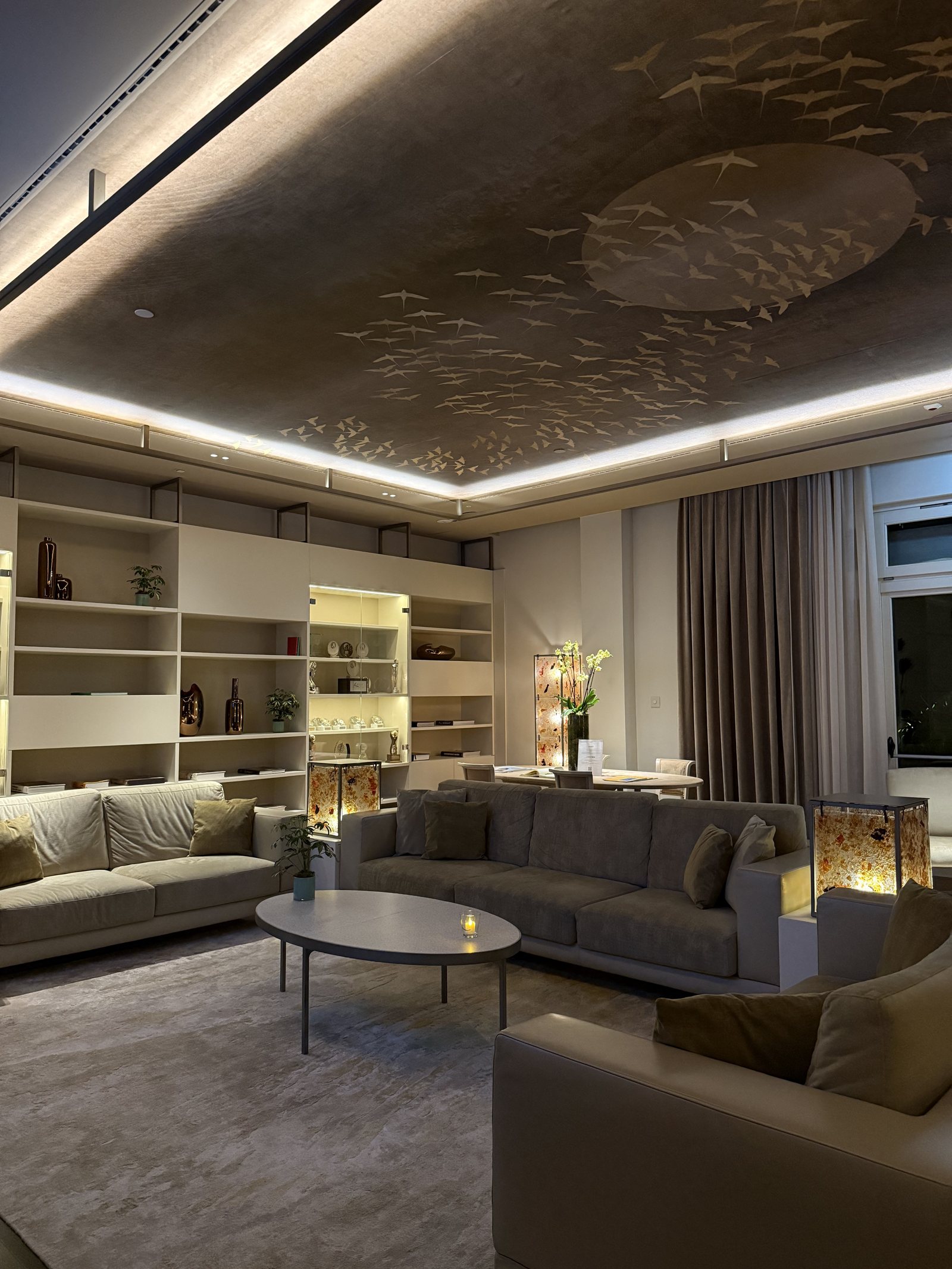 A sitting room with a ceiling panel worked with a shoal of small golden fish