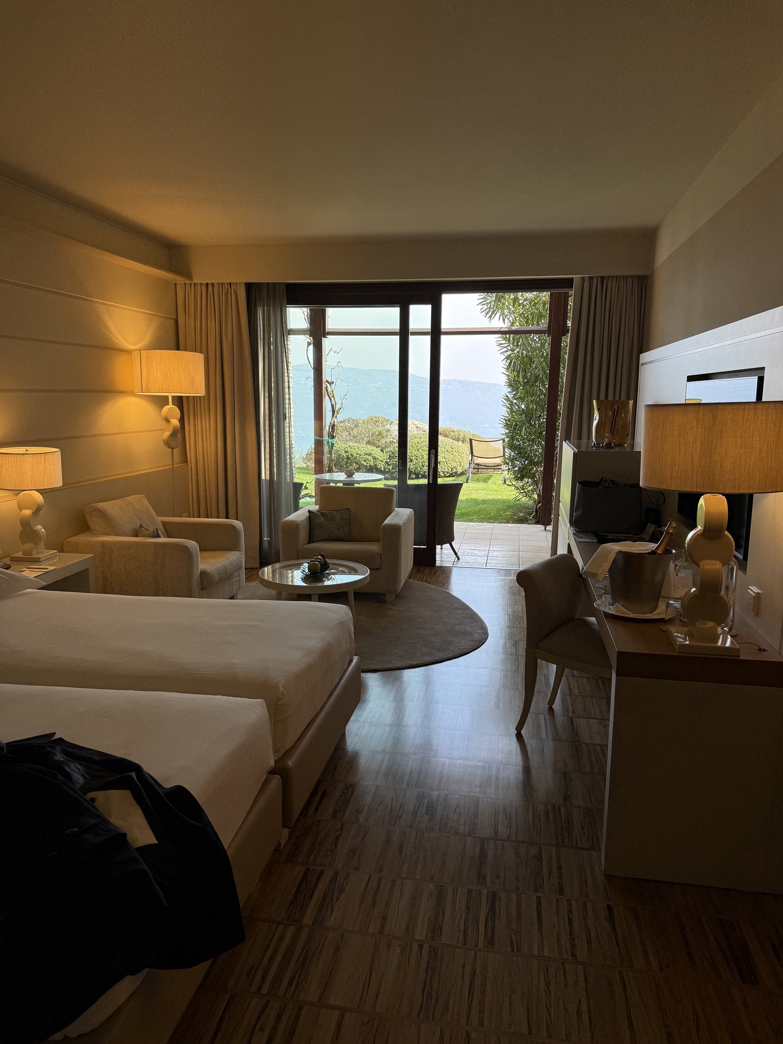 The suite seen from the entrance, bed on the left, seating and glass doors at the far end