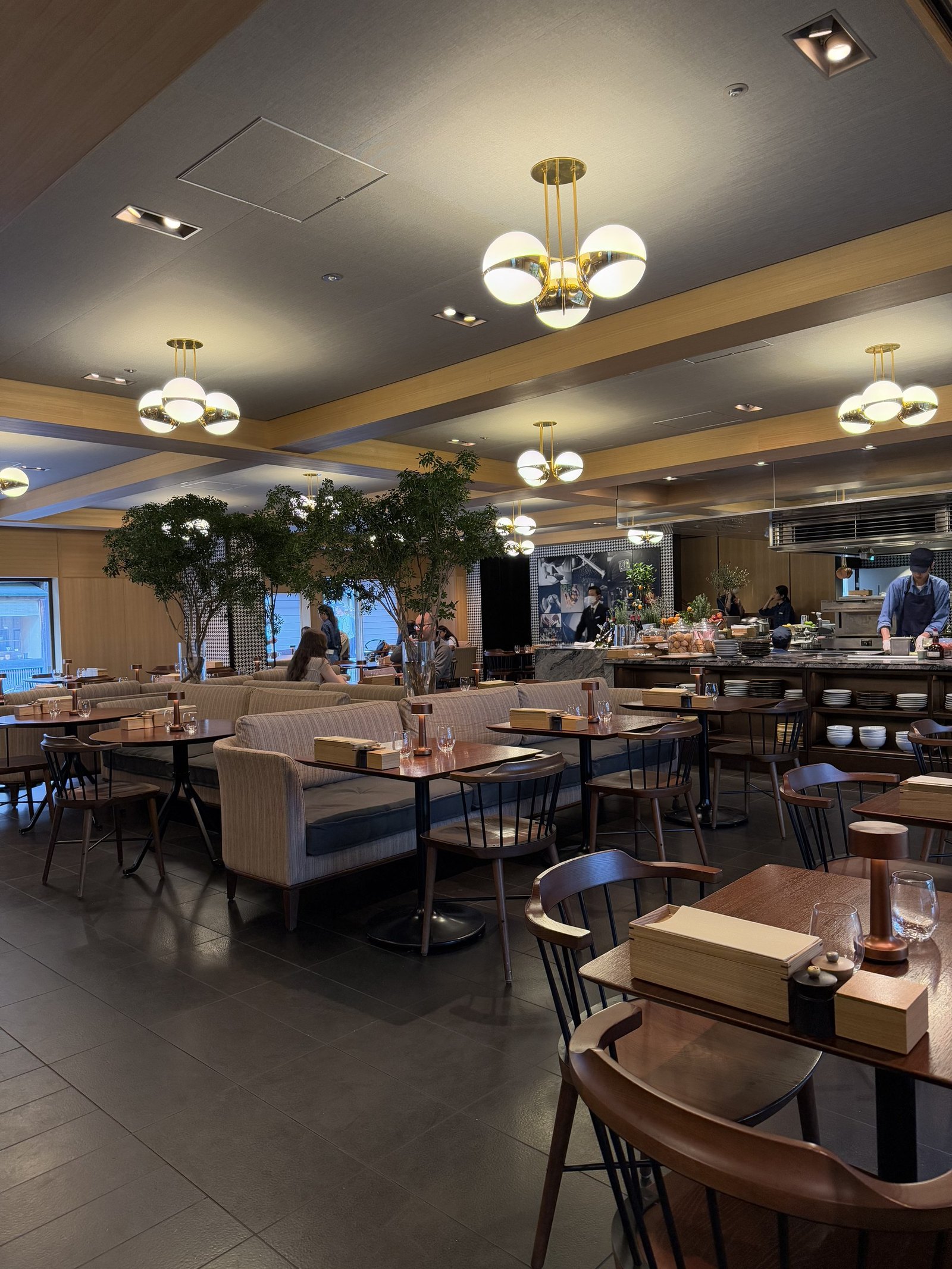 The breakfast room with timber tables and a long counter of food