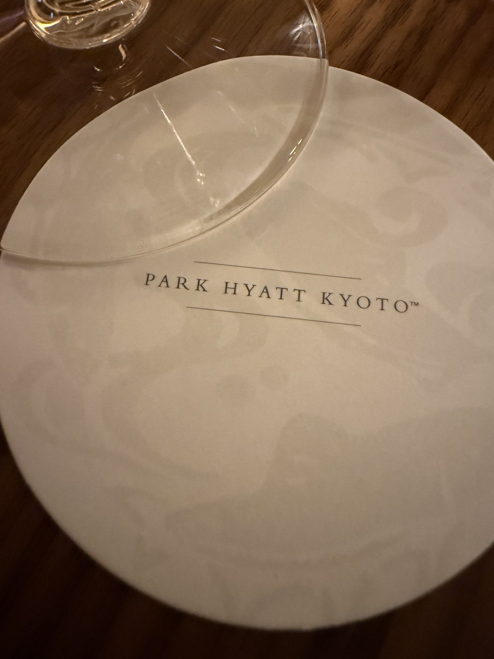 A coaster printed Park Hyatt Kyoto under the base of a glass