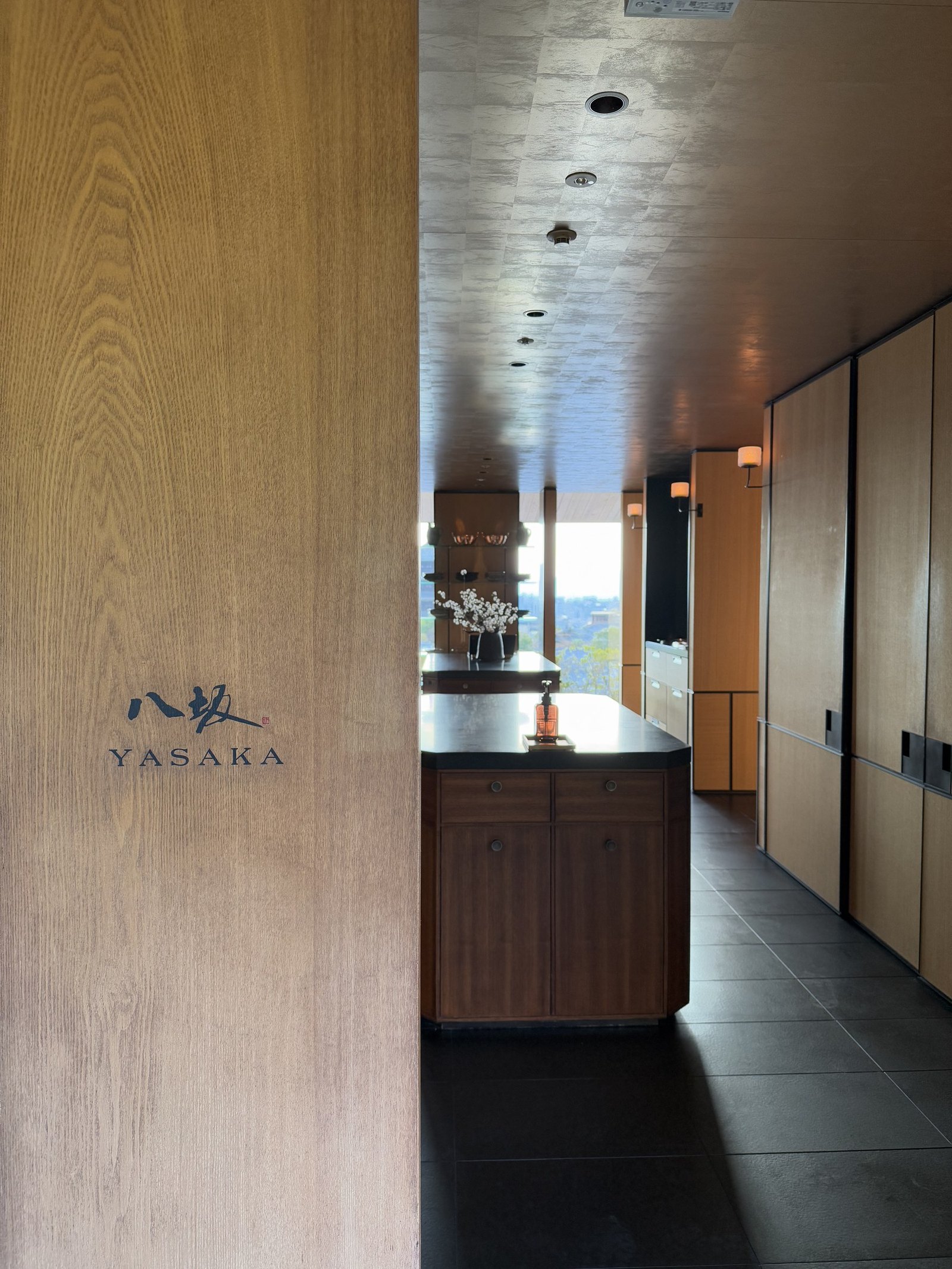 The timber entrance to Yasaka with the restaurant name carved into the wall