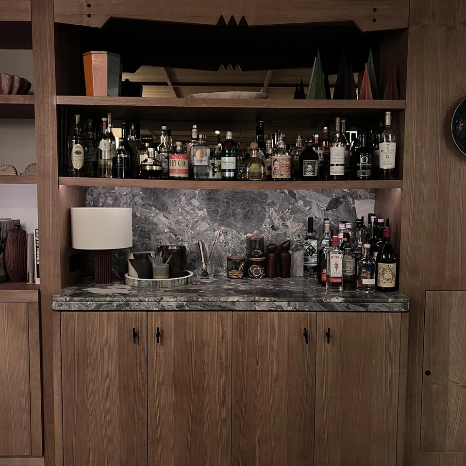 The bar shelves at The Brecon lined with bottles under a timber canopy