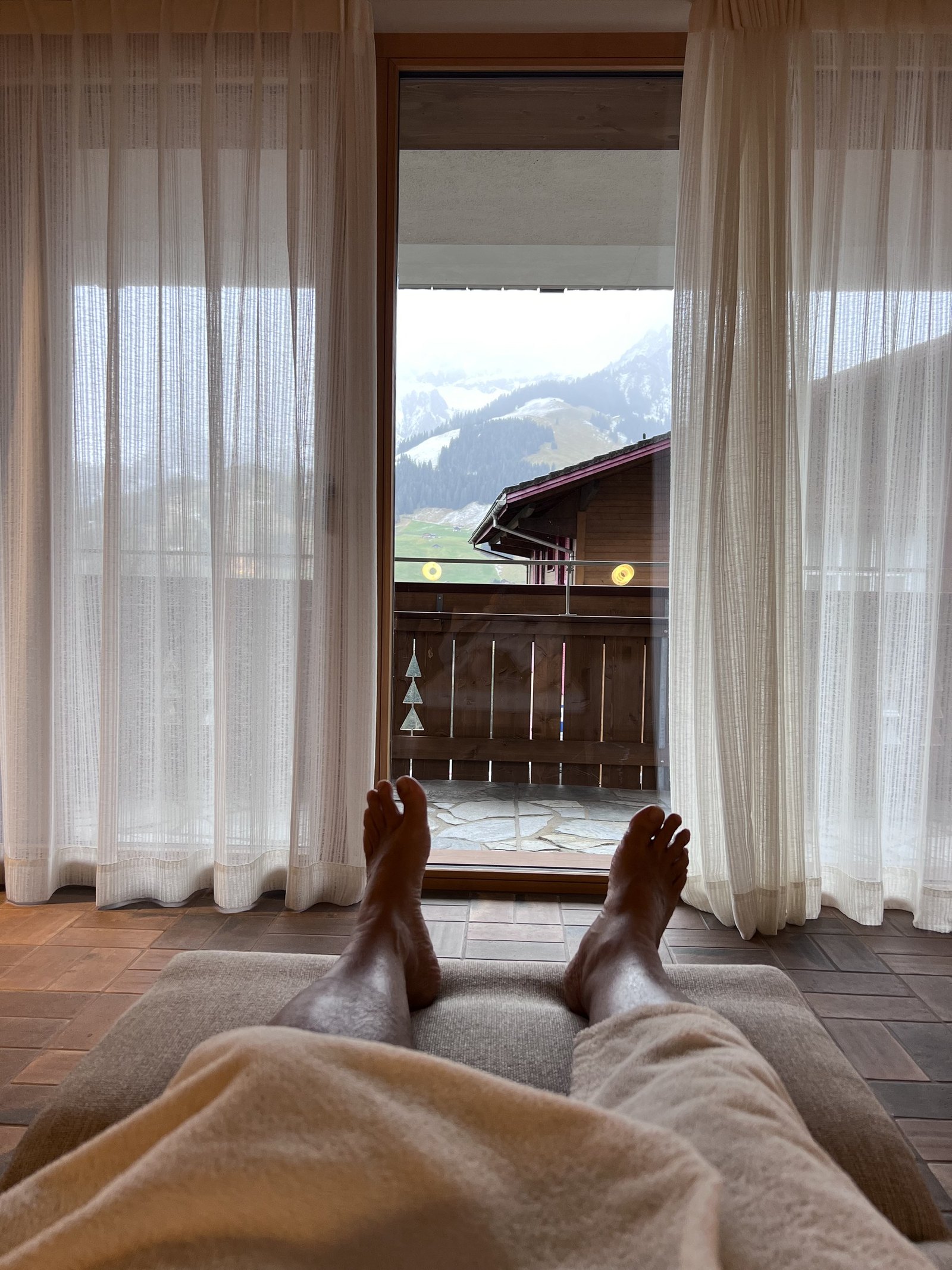 The view from the bed at The Brecon past the duvet to the mountain framed in the window