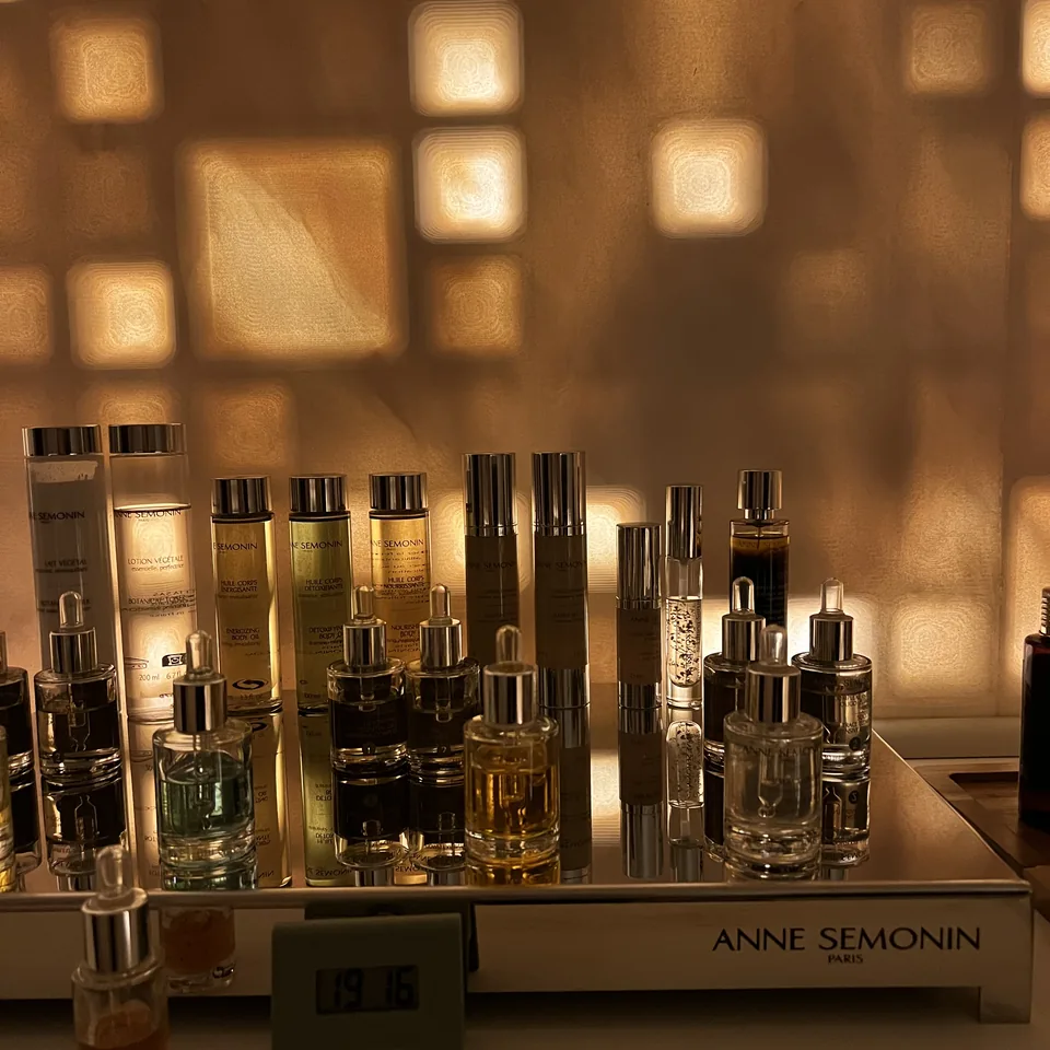 Anne Semonin bottles on a shelf in the spa, in dappled afternoon light