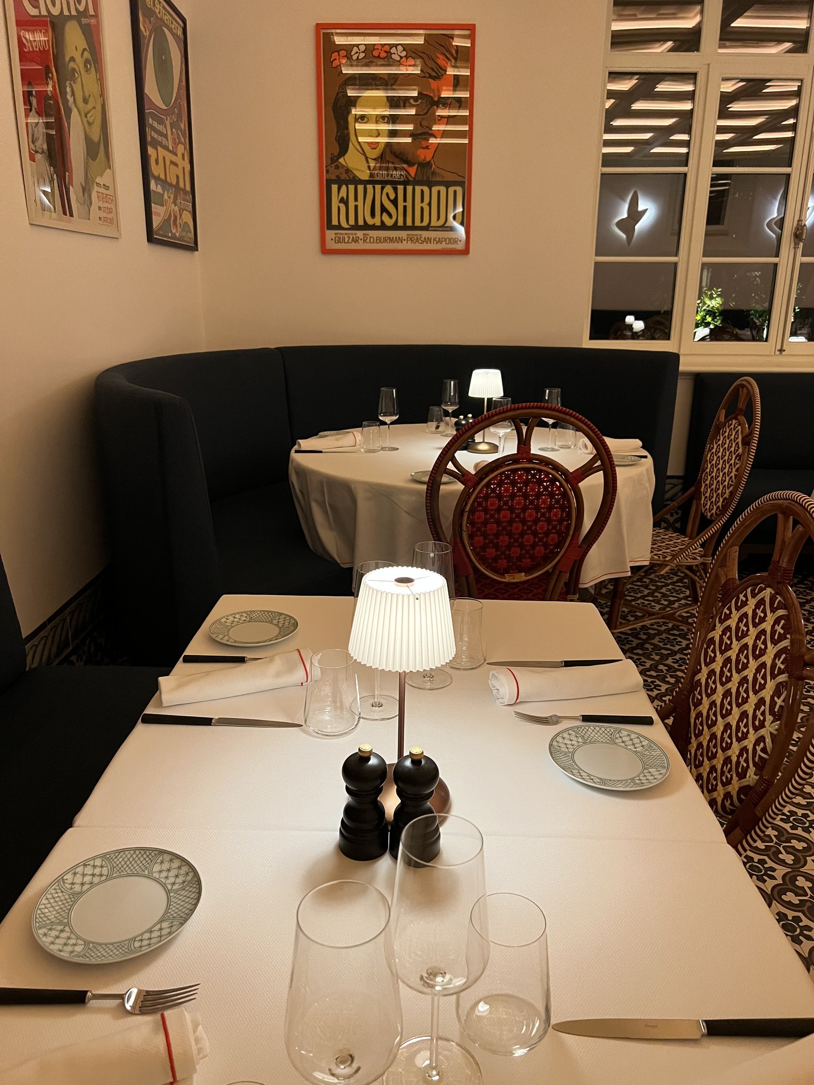 A table at Xtian laid with hand-painted plates from Melides and a printed menu