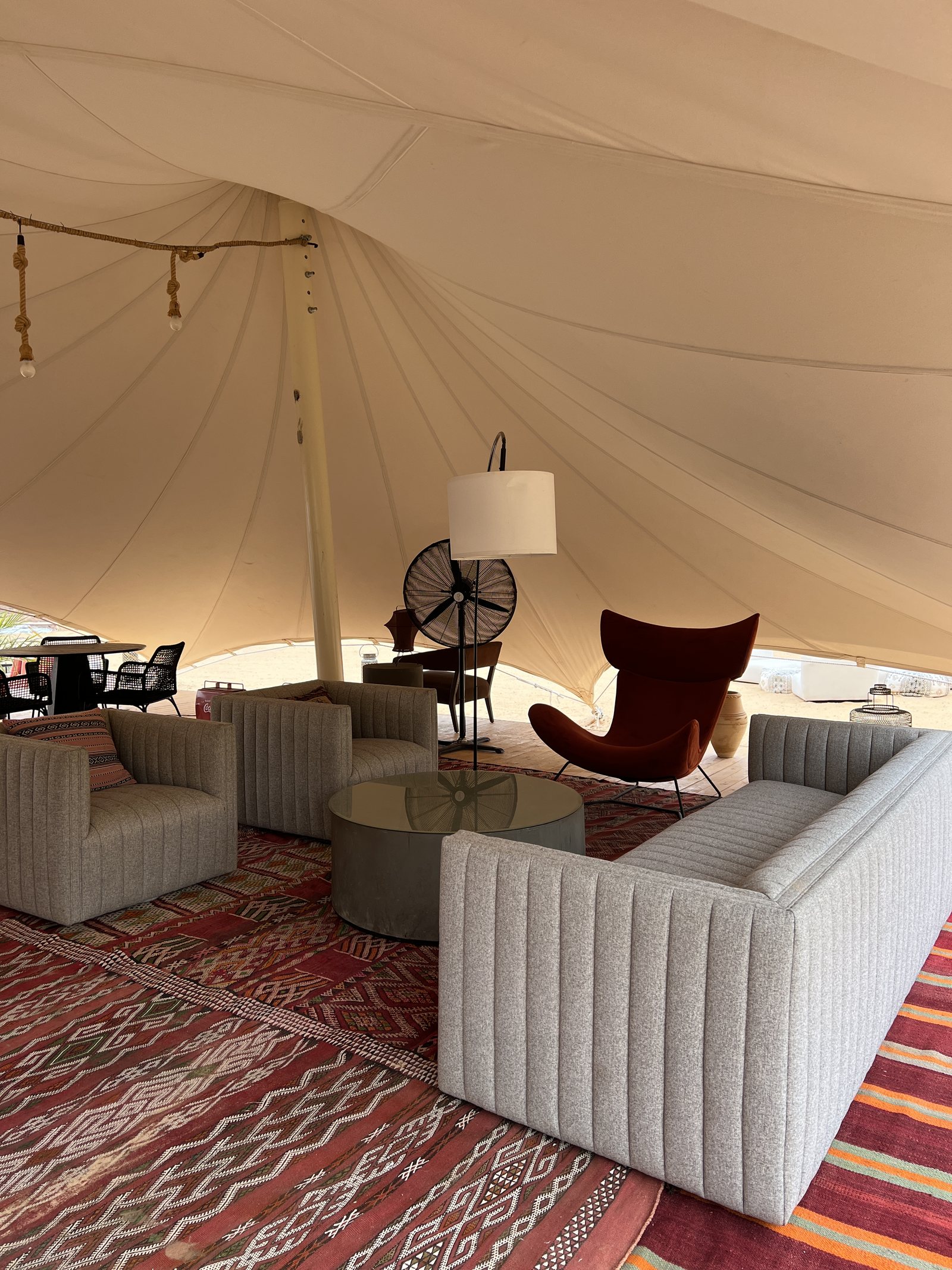 A lounge under a tented ceiling, with kilims on the floor