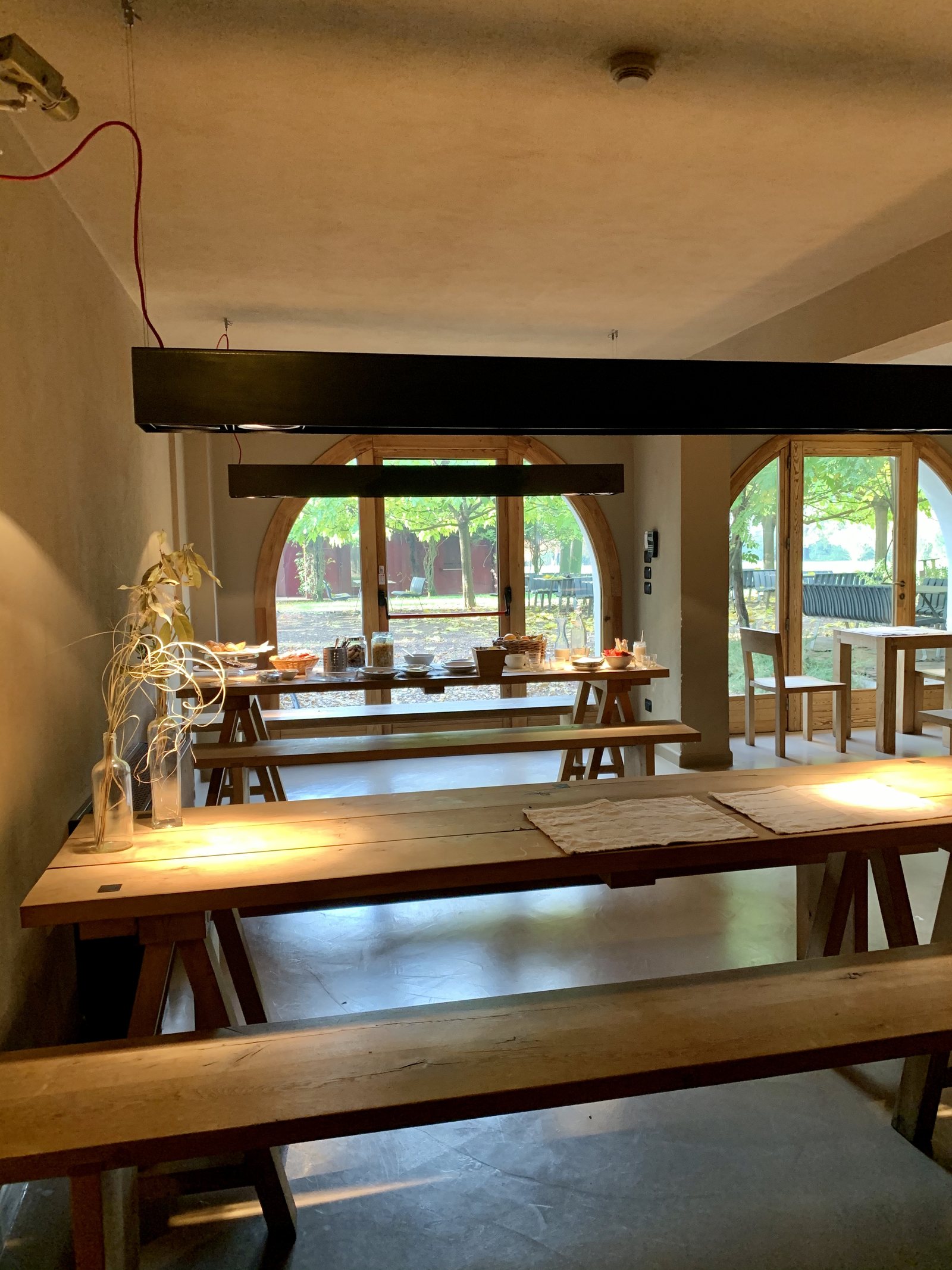 Trestle tables in a row under arched windows