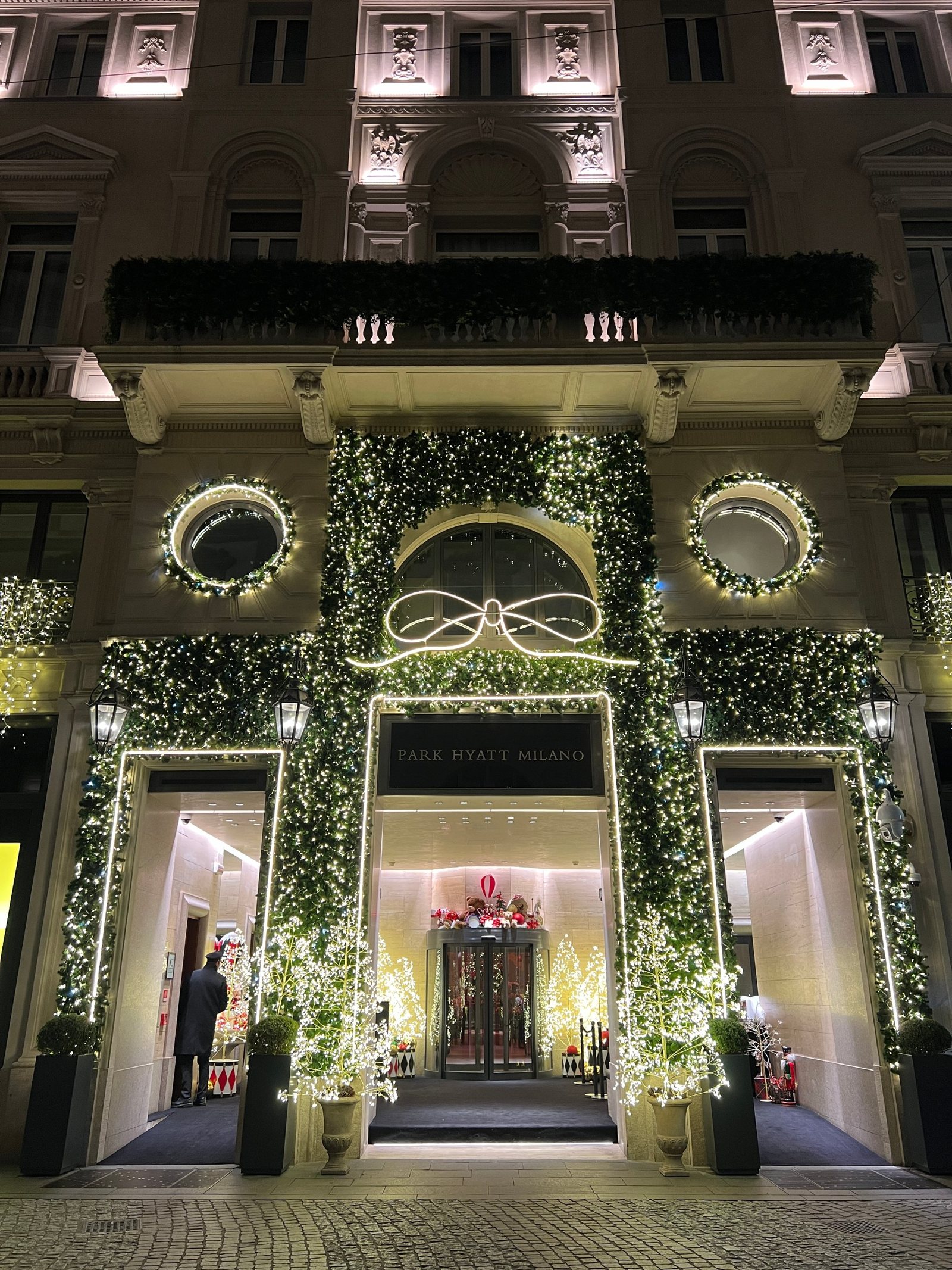 The entrance of Park Hyatt Milano under its winter lights